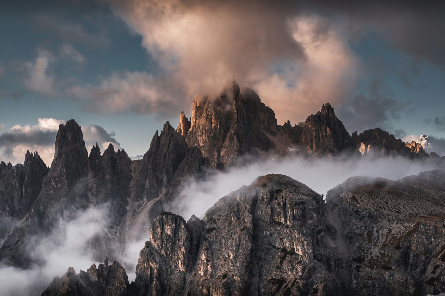 Rock spires wrapped in cloud at sunset